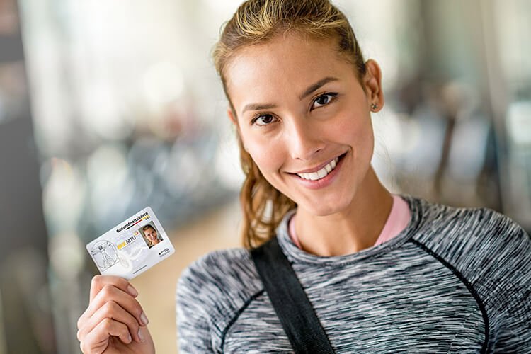 woman holding her electronic health insurance card