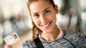 woman holding her electronic health insurance card