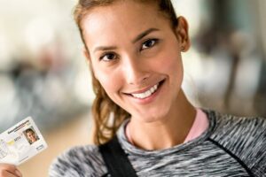 woman holding her electronic health insurance card